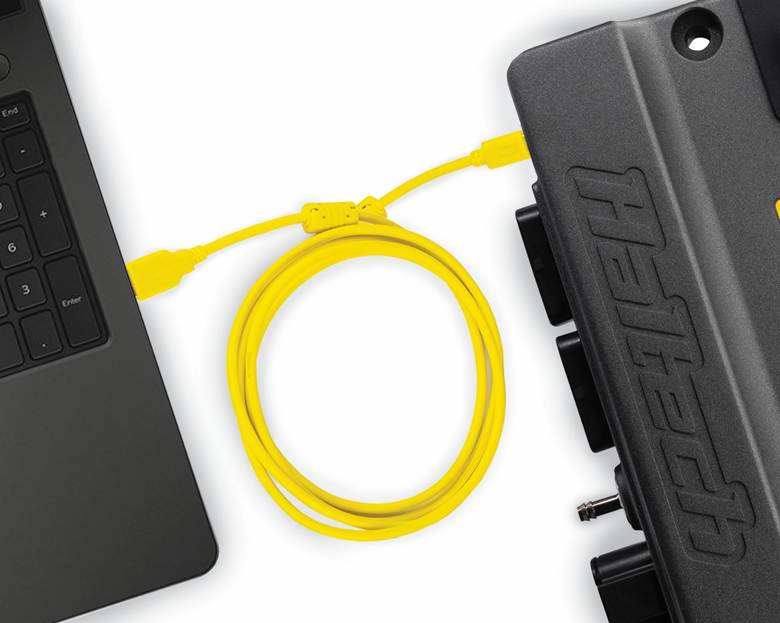 A black computer with a yellow cable

AI-generated content may be incorrect.